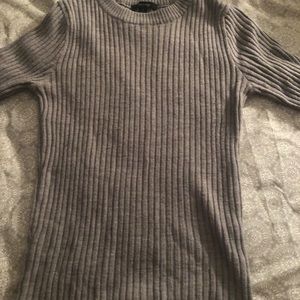 tight grey long sleeved shirt